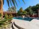Inviting pool area featuring a tiled deck, fire bowls, and a covered outdoor lounge at 11571 E Cochise Dr, Scottsdale, AZ 85259