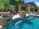 An inviting pool and spa area with fire features create a serene and luxurious outdoor living space at 11571 E Cochise Dr, Scottsdale, AZ 85259