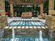 The backyard features a tranquil spa with stone accents and a pergola, perfect for relaxation and entertaining at 11571 E Cochise Dr, Scottsdale, AZ 85259