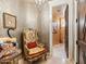 Elegant sitting room features decorative wallpaper, stylish armchair, and ornate accents at 11571 E Cochise Dr, Scottsdale, AZ 85259