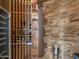 Custom wine cellar with ample storage and stone accents at 11571 E Cochise Dr, Scottsdale, AZ 85259