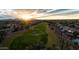 Scenic aerial view of a golf course community with lush green fairways at sunset at 12808 W Nogales Dr, Sun City West, AZ 85375