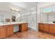 Spacious primary bathroom featuring dual sinks, vanity area, walk-in shower, and tile flooring at 12808 W Nogales Dr, Sun City West, AZ 85375