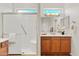 Bathroom featuring a glass enclosed shower with seat, dual vanity and neutral color palette at 12808 W Nogales Dr, Sun City West, AZ 85375