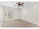 Neutral bedroom featuring a ceiling fan, carpet flooring and plenty of natural light from the window at 12808 W Nogales Dr, Sun City West, AZ 85375