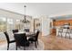 Dining room with chandelier, table and kitchen area in background at 12808 W Nogales Dr, Sun City West, AZ 85375