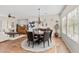 Bright dining room with a round table, leather chairs, and decorative chandelier at 12808 W Nogales Dr, Sun City West, AZ 85375