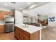 Open kitchen layout with an island, stainless steel appliances, and views into the living area at 12808 W Nogales Dr, Sun City West, AZ 85375