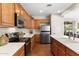Modern kitchen featuring white countertops, stainless steel appliances, and light wood cabinets at 12808 W Nogales Dr, Sun City West, AZ 85375
