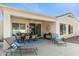 Wide angle shot of a covered patio with patio furniture and desert landscaping at 12808 W Nogales Dr, Sun City West, AZ 85375