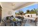 Covered patio with outdoor dining set, ceiling fan and backyard view at 12808 W Nogales Dr, Sun City West, AZ 85375