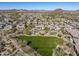 Aerial view showing a community with a large green space and houses with solar panels at 13359 W Baker Dr, Peoria, AZ 85383