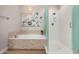 Bathroom with soaking tub, glass shower, and updated tile at 13450 E Via Linda Dr # 2008, Scottsdale, AZ 85259