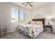 Cozy bedroom with ceiling fan, floral bedding, and a full-size bed at 13450 E Via Linda Dr # 2008, Scottsdale, AZ 85259