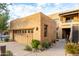 Tan stucco building with a two-car garage and desert landscaping at 13450 E Via Linda Dr # 2008, Scottsdale, AZ 85259