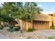 Two-car garage with wood-like garage doors and desert landscaping at 13450 E Via Linda Dr # 2008, Scottsdale, AZ 85259