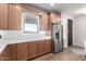 Kitchen with stainless steel refrigerator and light wood cabinets at 13450 E Via Linda Dr # 2008, Scottsdale, AZ 85259