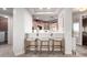 Kitchen breakfast bar with three light wood barstools at 13450 E Via Linda Dr # 2008, Scottsdale, AZ 85259