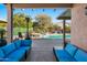 Inviting backyard oasis featuring a sparkling pool, spa, and patio furniture at 15174 W Camino Estrella Dr, Surprise, AZ 85374