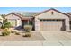 Single-story home with solar panels and a two-car garage at 15174 W Camino Estrella Dr, Surprise, AZ 85374