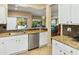 Kitchen offers granite counters, stainless steel appliances, and views of the pool at 15174 W Camino Estrella Dr, Surprise, AZ 85374