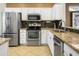 Modern kitchen featuring stainless steel appliances and granite countertops at 15174 W Camino Estrella Dr, Surprise, AZ 85374