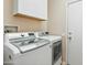 Convenient laundry room with side-by-side washer and dryer at 15174 W Camino Estrella Dr, Surprise, AZ 85374