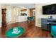 Open living area with hardwood floors and a view into the kitchen at 15174 W Camino Estrella Dr, Surprise, AZ 85374