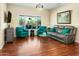 Relaxing living room featuring hardwood floors and large windows at 15174 W Camino Estrella Dr, Surprise, AZ 85374