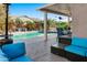 Relaxing patio with pool views, comfortable seating, and outdoor heater at 15174 W Camino Estrella Dr, Surprise, AZ 85374