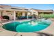 Large kidney shaped pool with surrounding patio and seating at 15174 W Camino Estrella Dr, Surprise, AZ 85374