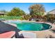 Stunning kidney-shaped pool with a spa and plenty of lounge space at 15174 W Camino Estrella Dr, Surprise, AZ 85374