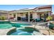 Relaxing pool and spa area with plenty of seating and a covered patio at 15174 W Camino Estrella Dr, Surprise, AZ 85374
