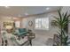 Cozy living room featuring a teal sofa and wood accent chairs at 155 N Lakeview Blvd # 118, Chandler, AZ 85225