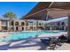 Community pool with lounge chairs and shade umbrellas at 155 N Lakeview Blvd # 118, Chandler, AZ 85225