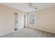 Well-lit bedroom with sliding closet doors and a window with blinds at 16585 W Tonto St, Goodyear, AZ 85338