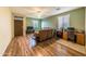 Living room with hardwood floors and a view into the kitchen at 17332 W Jefferson St, Goodyear, AZ 85338