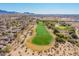 Aerial view showcasing a golf course and surrounding homes at 19550 N Grayhawk Dr # 1124, Scottsdale, AZ 85255