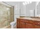 Bathroom with granite vanity, shower, and toilet at 19550 N Grayhawk Dr # 1124, Scottsdale, AZ 85255