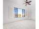 Bright bedroom with large window and plantation shutters at 19550 N Grayhawk Dr # 1124, Scottsdale, AZ 85255