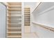 Spacious walk-in closet with ample shelving and hanging rods at 19550 N Grayhawk Dr # 1124, Scottsdale, AZ 85255