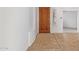 Interior entryway with tiled floors and a wooden door at 19550 N Grayhawk Dr # 1124, Scottsdale, AZ 85255