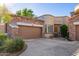 Front view of a beautiful home with stone accents and a two-car garage at 19550 N Grayhawk Dr # 1124, Scottsdale, AZ 85255
