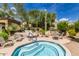 Community hot tub with plenty of seating and nearby lounge chairs at 19550 N Grayhawk Dr # 1124, Scottsdale, AZ 85255