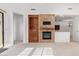 Open living area with fireplace, built-ins, and access to a patio at 19550 N Grayhawk Dr # 1124, Scottsdale, AZ 85255