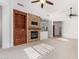 Bright living room featuring a stone fireplace and built-in cabinetry at 19550 N Grayhawk Dr # 1124, Scottsdale, AZ 85255