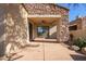 Covered patio with stone facade and sliding glass doors at 19550 N Grayhawk Dr # 1124, Scottsdale, AZ 85255