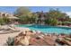 Inviting community pool with a waterfall feature and lounge chairs at 19550 N Grayhawk Dr # 1124, Scottsdale, AZ 85255