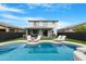 Backyard featuring a refreshing pool, lounge chairs, and lush green grass at 22501 E Indiana Ave, Queen Creek, AZ 85142