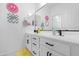 Bright bathroom featuring a double vanity with sleek black hardware, and fun wall decor at 22501 E Indiana Ave, Queen Creek, AZ 85142